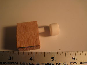 Cylindrical piece relative to oak block?